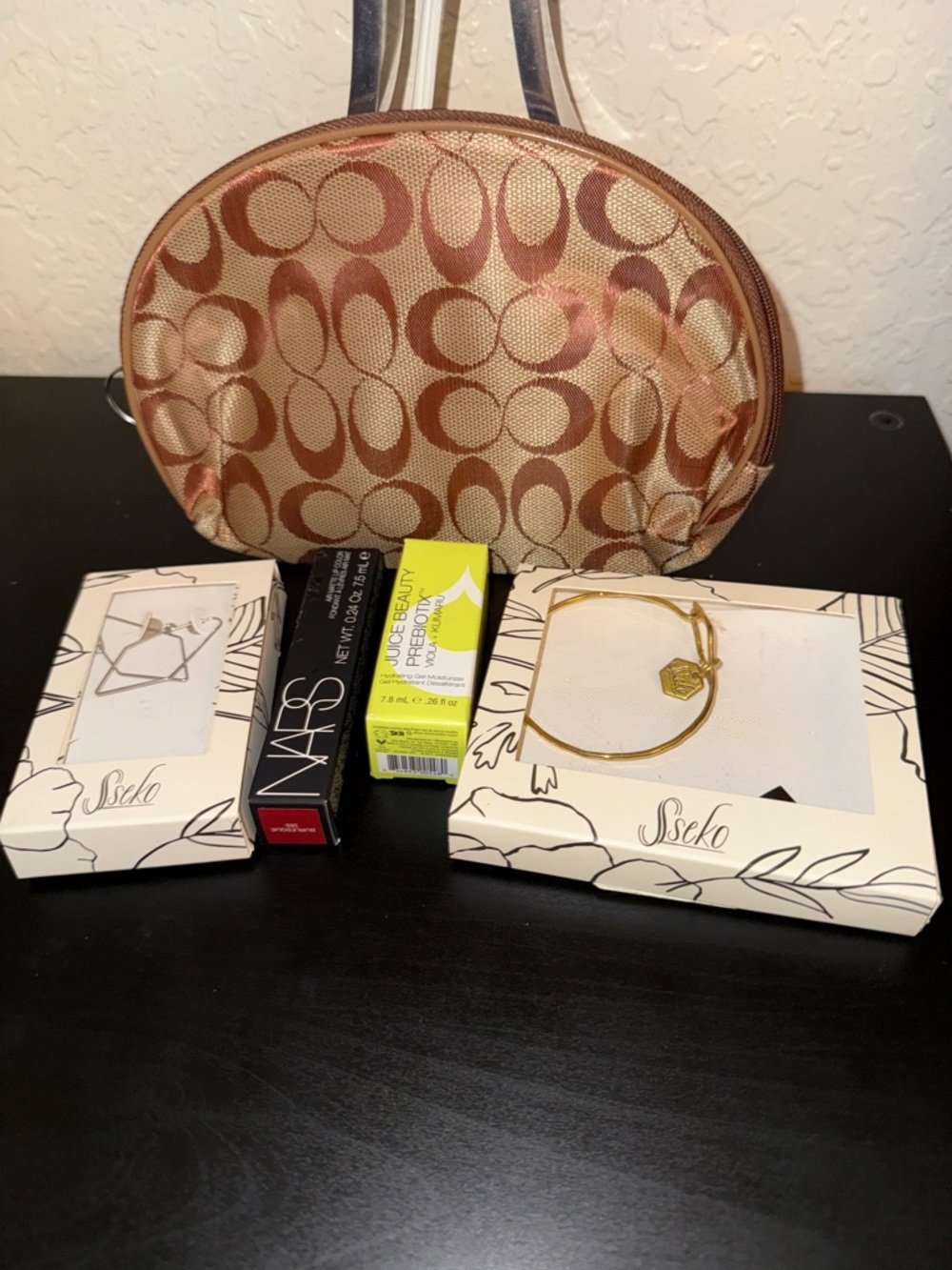 NARS Lip color. Juice Beauty Moisturizer.Sseko bracelet and earrings, pouch
